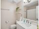 Bright bathroom features a white vanity, decorative shelves, and a large mirror, enhancing the space at 921 Torchwood Dr, Deland, FL 32724
