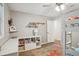 Bedroom featuring hardwood floors, a bunk bed, closet, bookshelf, desk, and colorful rug at 921 Torchwood Dr, Deland, FL 32724