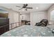 Spacious bedroom features wood floors, closet, massage chair and TV for comfort at 921 Torchwood Dr, Deland, FL 32724