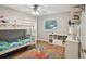 Bedroom with hardwood floors, bunk bed, bookshelf, desk, and bright natural light at 921 Torchwood Dr, Deland, FL 32724