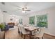 Charming dining room with a wooden table and comfortable upholstered chairs, filled with natural light at 921 Torchwood Dr, Deland, FL 32724