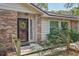 Welcoming home entrance featuring a stylish front door and lush landscape at 921 Torchwood Dr, Deland, FL 32724