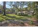 Well-maintained home with a lush green lawn, mature trees, and inviting curb appeal at 921 Torchwood Dr, Deland, FL 32724