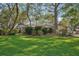 A lush green front yard featuring mature trees and established landscaping at 921 Torchwood Dr, Deland, FL 32724