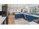 Modern kitchen featuring blue cabinets, stainless steel appliances, and an open layout at 921 Torchwood Dr, Deland, FL 32724