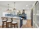 Modern kitchen with blue cabinets, stainless steel appliances, and a breakfast bar with seating at 921 Torchwood Dr, Deland, FL 32724