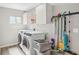 Well-organized laundry room with washer, dryer, storage cabinets and shelving, combining functionality and style at 921 Torchwood Dr, Deland, FL 32724