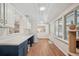 Bright living room with hardwood floors, plenty of natural light, white ceiling, and blue and white cabinets at 921 Torchwood Dr, Deland, FL 32724