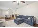 Open concept living room with a comfortable blue sectional sofa at 921 Torchwood Dr, Deland, FL 32724