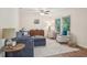 Bright living room featuring a cozy blue sectional sofa, and natural light from large windows at 921 Torchwood Dr, Deland, FL 32724