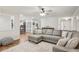 Inviting living room with a plush sectional sofa, bright lighting, and wood flooring at 921 Torchwood Dr, Deland, FL 32724