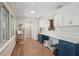 Bright living room featuring hardwood floors, many windows, cat tree, and blue and white cabinets at 921 Torchwood Dr, Deland, FL 32724