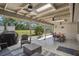 Expansive covered patio with an outdoor dining and seating area, ideal for relaxation and entertaining at 921 Torchwood Dr, Deland, FL 32724