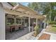 Covered patio with outdoor dining and seating areas creates a perfect space for entertaining and relaxing at 921 Torchwood Dr, Deland, FL 32724