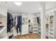 Large walk-in closet featuring lots of shelving, organized storage, and hardwood floors at 921 Torchwood Dr, Deland, FL 32724