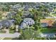 A beautiful home is showcased in an aerial view, complete with lush landscaping and a well-maintained yard at 968 Ashton Oaks Cir, Lakeland, FL 33813