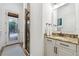 Well-lit bathroom featuring a granite vanity, neutral tile, and access to the outdoor pool area at 968 Ashton Oaks Cir, Lakeland, FL 33813