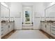Elegant bathroom featuring dual vanities, large mirrors, and a luxurious soaking tub under window at 968 Ashton Oaks Cir, Lakeland, FL 33813