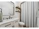 Modern bathroom with marble countertops, dark fixtures, and a stylish shower curtain at 968 Ashton Oaks Cir, Lakeland, FL 33813