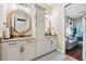 Bathroom featuring double vanity with decorative framed mirrors and stylish white cabinetry at 968 Ashton Oaks Cir, Lakeland, FL 33813