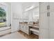 Bright bathroom features a granite countertop vanity and a soaking tub under a large window at 968 Ashton Oaks Cir, Lakeland, FL 33813