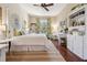 Bright bedroom with hardwood floors, natural lighting, white furnishings, and a ceiling fan at 968 Ashton Oaks Cir, Lakeland, FL 33813
