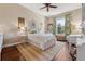 Bright bedroom with hardwood floors, natural lighting, and elegant white furnishings at 968 Ashton Oaks Cir, Lakeland, FL 33813