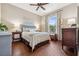Bedroom features hardwood floors, a large window, and a classic blue headboard at 968 Ashton Oaks Cir, Lakeland, FL 33813