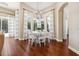 Bright dining room featuring hardwood floors, large windows, and an elegant chandelier above a round table at 968 Ashton Oaks Cir, Lakeland, FL 33813