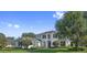 Beautiful two-story home with manicured lawn, lush landscaping, and classic architectural details at 968 Ashton Oaks Cir, Lakeland, FL 33813