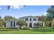 Charming two-story home with a well-kept lawn and manicured hedges and shrubs at 968 Ashton Oaks Cir, Lakeland, FL 33813