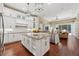 Spacious kitchen features white cabinets, granite countertops, stainless steel appliances and a center island at 968 Ashton Oaks Cir, Lakeland, FL 33813