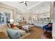 Spacious living room features a sectional sofa, hardwood floors, and an open concept design at 968 Ashton Oaks Cir, Lakeland, FL 33813