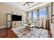 Bright living room with large windows, tray ceiling, and a comfortable sofa at 968 Ashton Oaks Cir, Lakeland, FL 33813