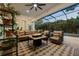 Comfortable screened patio with a cozy seating area, stylish rug, and beautiful pool and backyard views at 968 Ashton Oaks Cir, Lakeland, FL 33813