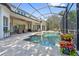 An inviting screened-in pool area with pavers and comfortable seating, perfect for outdoor relaxation and entertainment at 968 Ashton Oaks Cir, Lakeland, FL 33813