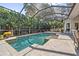 The screened-in pool has a beautiful design, with a step-in area and lush landscaping, creating a private backyard oasis at 968 Ashton Oaks Cir, Lakeland, FL 33813