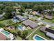 An aerial view of a home with fenced yard, pool, deck, landscaping and play set. Borders highlighted in red at 986 Stonewood Ln, Maitland, FL 32751