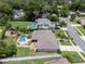 An aerial view of a home featuring a pool, manicured yard, deck, and a play set at 986 Stonewood Ln, Maitland, FL 32751