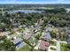An aerial view of a neighborhood with homes, lush greenery, and a scenic lake in the background at 986 Stonewood Ln, Maitland, FL 32751