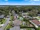 Aerial view of a residential neighborhood with lush trees, back yard swimming pools and clear blue skies at 986 Stonewood Ln, Maitland, FL 32751