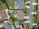 Bird's eye view of a home featuring a swimming pool, patio furniture, landscaping, and green lawns at 986 Stonewood Ln, Maitland, FL 32751