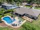 Aerial view of a private backyard oasis featuring a pool, deck, screened-in patio, and lush landscaping at 986 Stonewood Ln, Maitland, FL 32751