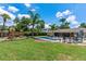 Lush backyard featuring a pool, patio, and playground, offering a versatile outdoor space for Gathering enjoyment at 986 Stonewood Ln, Maitland, FL 32751