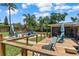 Relaxing backyard deck with seating overlooking the pool, lawn, and lush landscaping at 986 Stonewood Ln, Maitland, FL 32751
