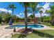 Beautiful backyard featuring a pool, playground, and ample green space, all surrounded by lush landscaping and a wooden fence at 986 Stonewood Ln, Maitland, FL 32751