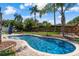 Sparkling backyard pool surrounded by lush greenery, comfortable seating, and a relaxing atmosphere at 986 Stonewood Ln, Maitland, FL 32751