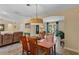Dining room with a four-chair wooden table adjacent to a living room space at 986 Stonewood Ln, Maitland, FL 32751