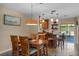 Inviting dining area with wooden table and chairs adjacent to kitchen, open to the outdoor patio at 986 Stonewood Ln, Maitland, FL 32751