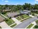 A charming single Gathering home with an expansive driveway, manicured lawn and lush landscaping on a sunny day at 986 Stonewood Ln, Maitland, FL 32751